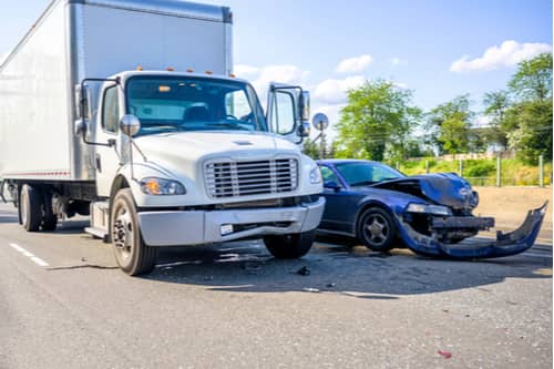 Car hit by semi truck, concept of truck accident injuries in Naples